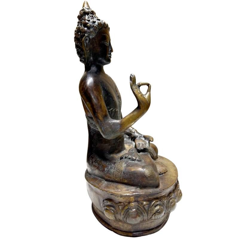 Antique bronze Buddha from the Himalayan tradition on a lotus base