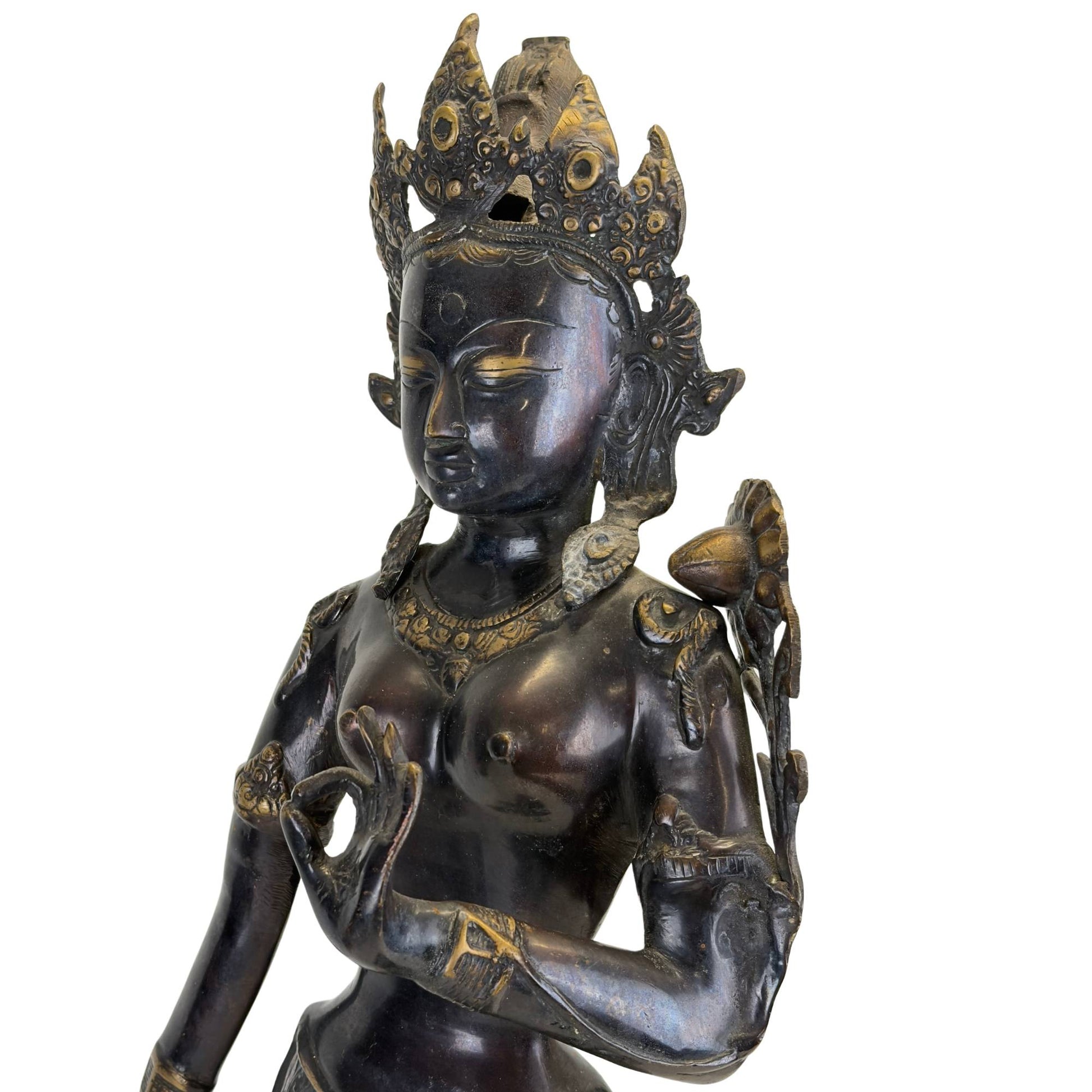 Close-up of the face and bust of an antique bronze Green Tara from the Kathmandu Valley, Nepal, with original fire gilding, black Newar patina, and richly detailed crown.