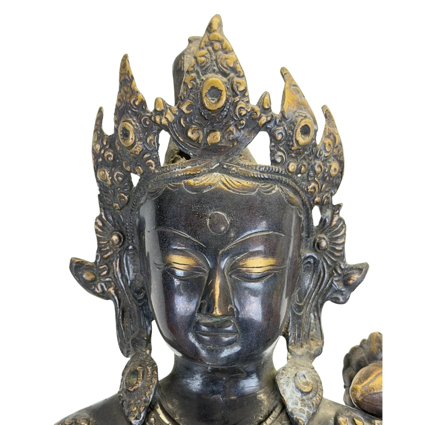 Detail of the richly decorated crown of an antique bronze Green Tara from the Kathmandu Valley, Nepal, with original fire gilding, black Newar patina, and hand-chiseled ornaments.