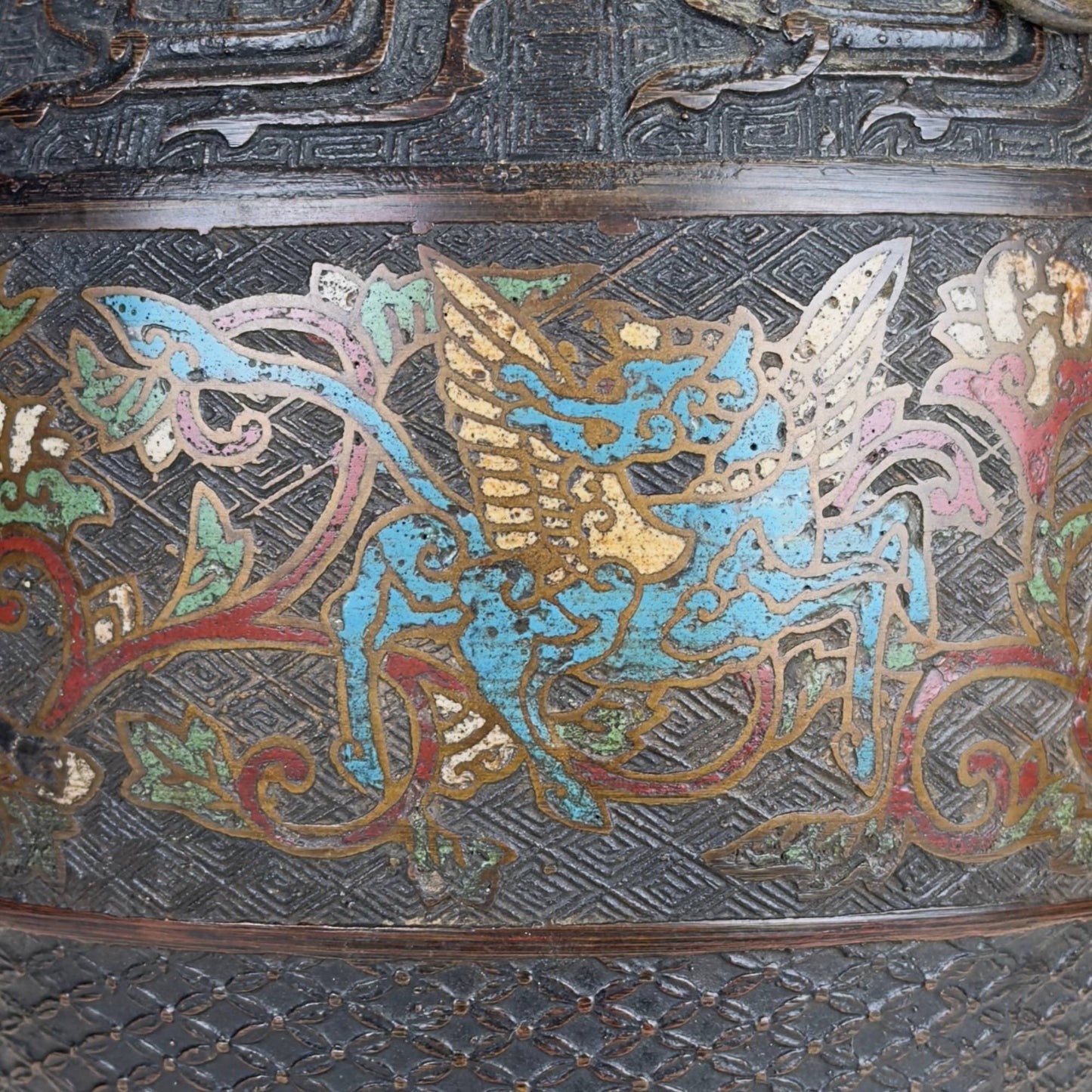 Antique Japanese champlevé vase in Meiji style with dark bronze, ring handles, and richly decorated enamel band.