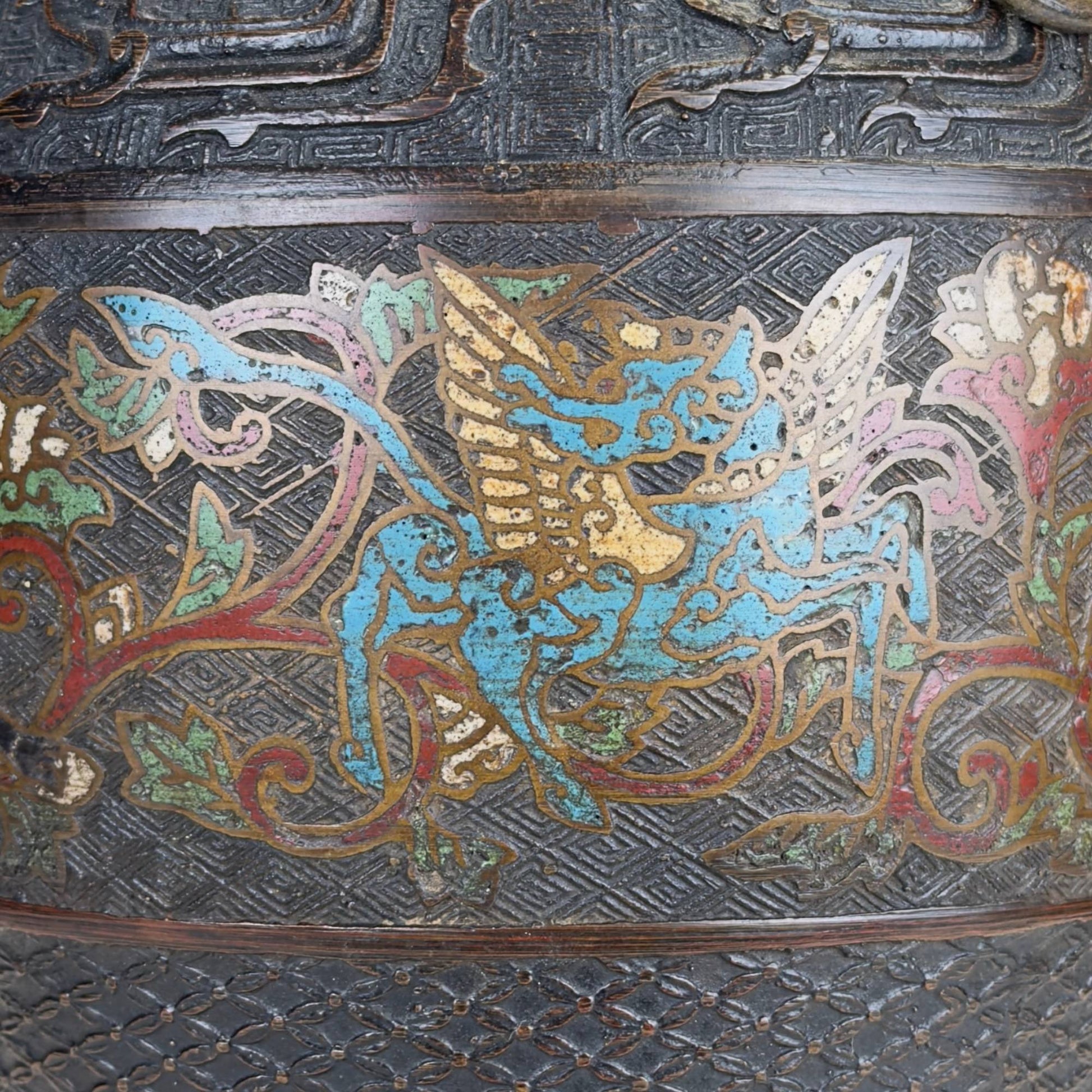 Antique Japanese champlevé vase in Meiji style with dark bronze, ring handles, and richly decorated enamel band.
