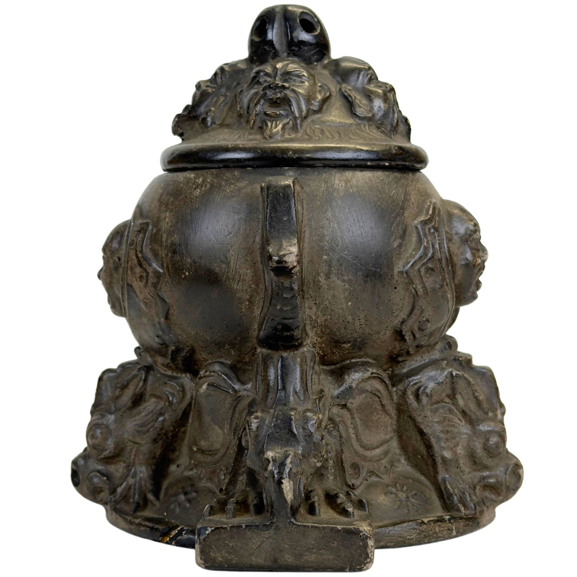 Antique pot with mythological masks and characterful patina