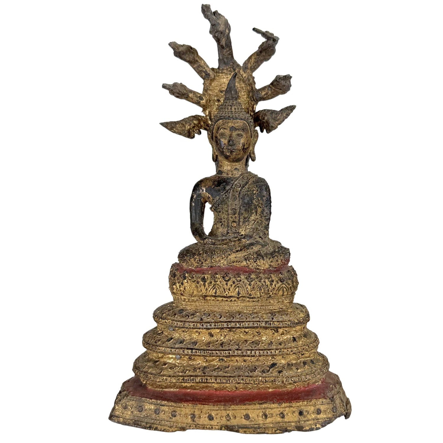 Antique gilded Thai Naga Buddha statue with Muchalinda protection on a high temple throne