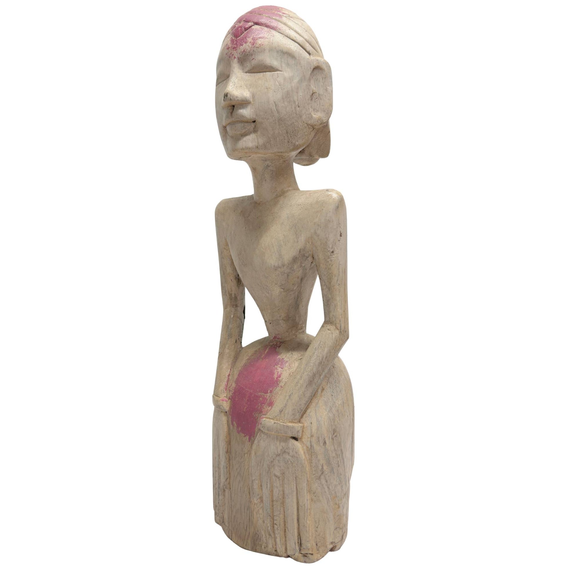 Detail of side view of tribal statue, focus on back and buttocks