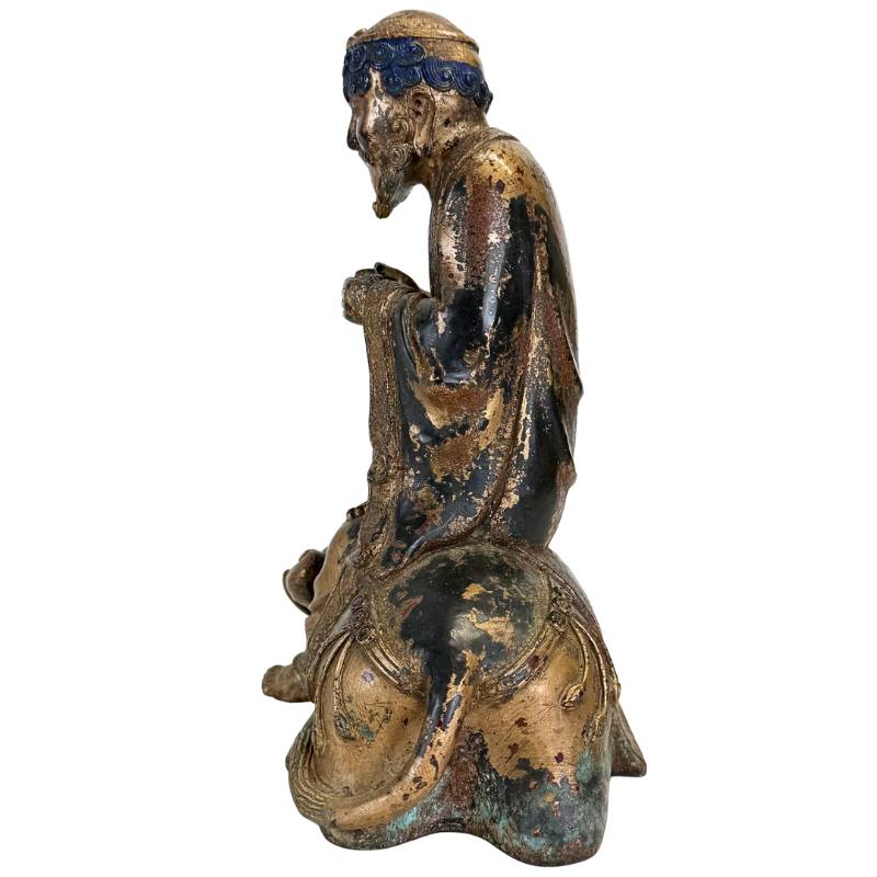 Arhat figure with Dano animal in bronze Himalayan style