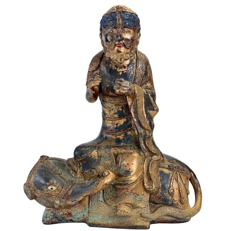 Arhat seated on Dano animal in bronze Himalayan statue