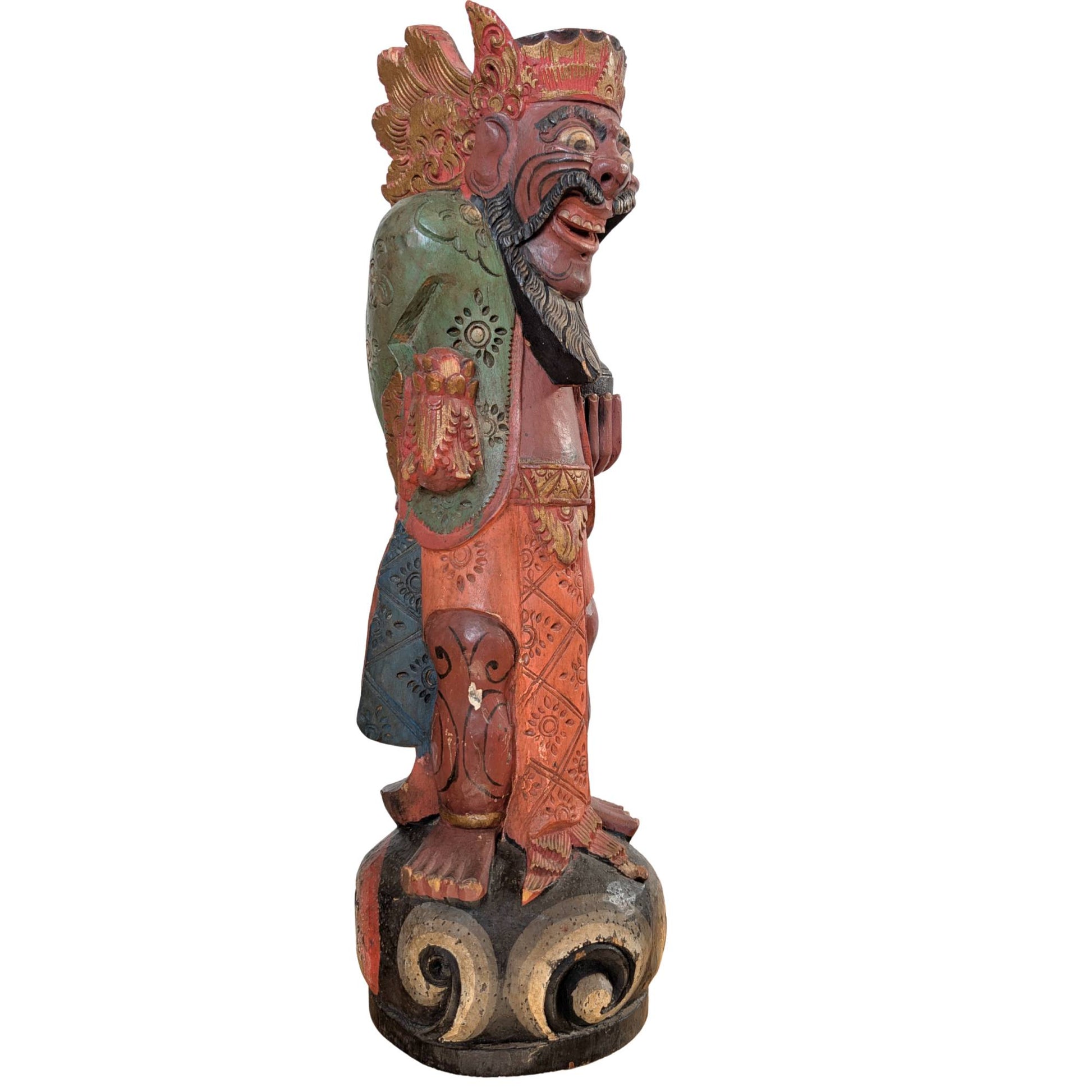 Detail of the expressive face and painting of the wooden Balinese temple guardian