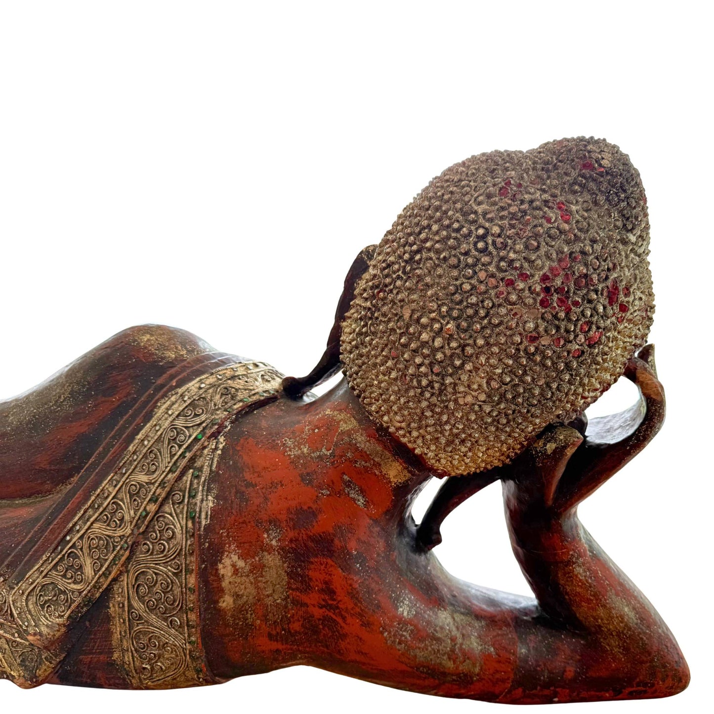 Side view of the hand-carved wooden Burmese Buddha in the specific Tuesday pose