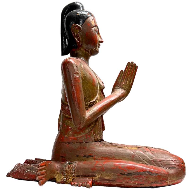 Burmese wooden statue with gold leaf and lacquer layers
