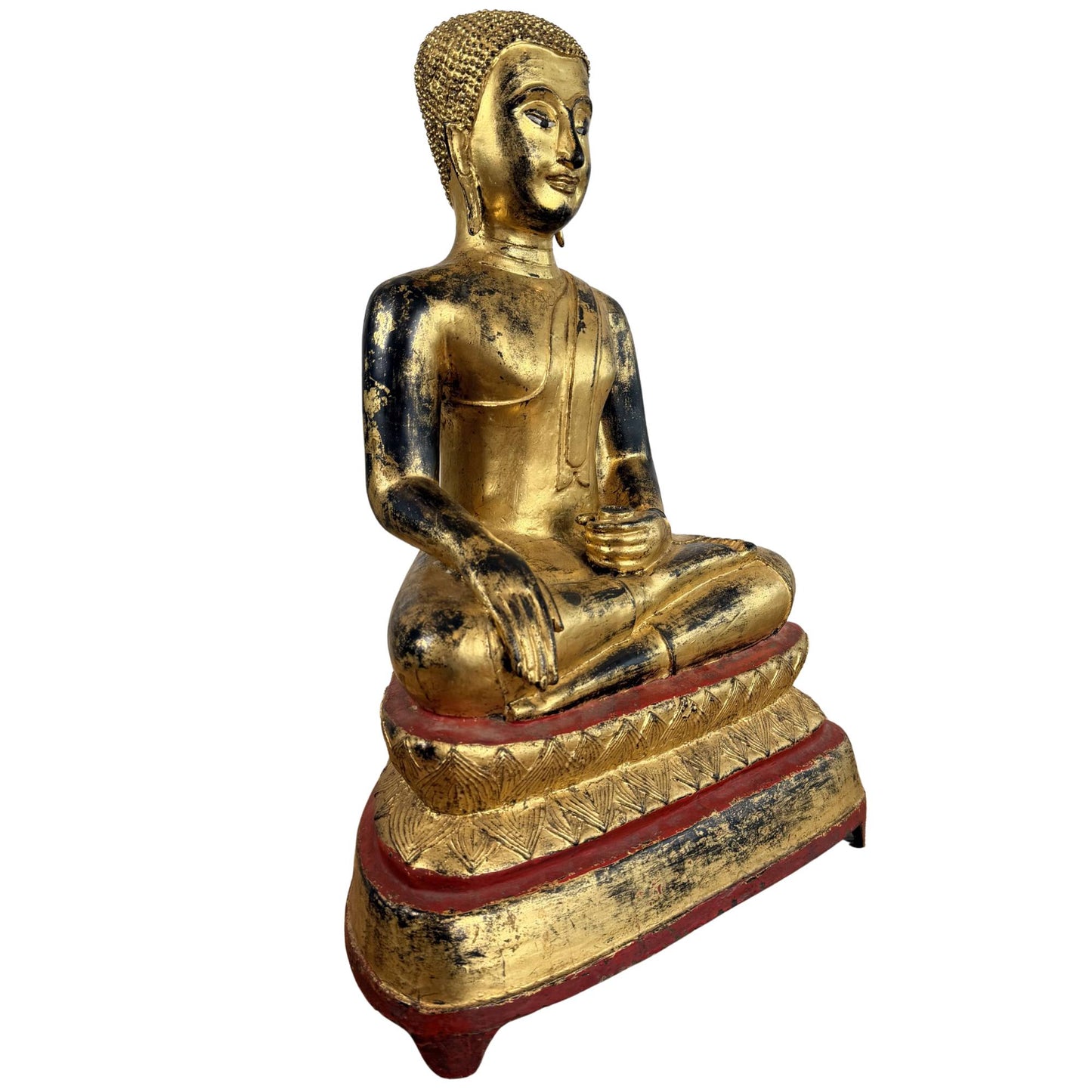 Burmese Buddha of gilded wood with a red lacquer base, black age-related wear, and a traditional spiritual appearance