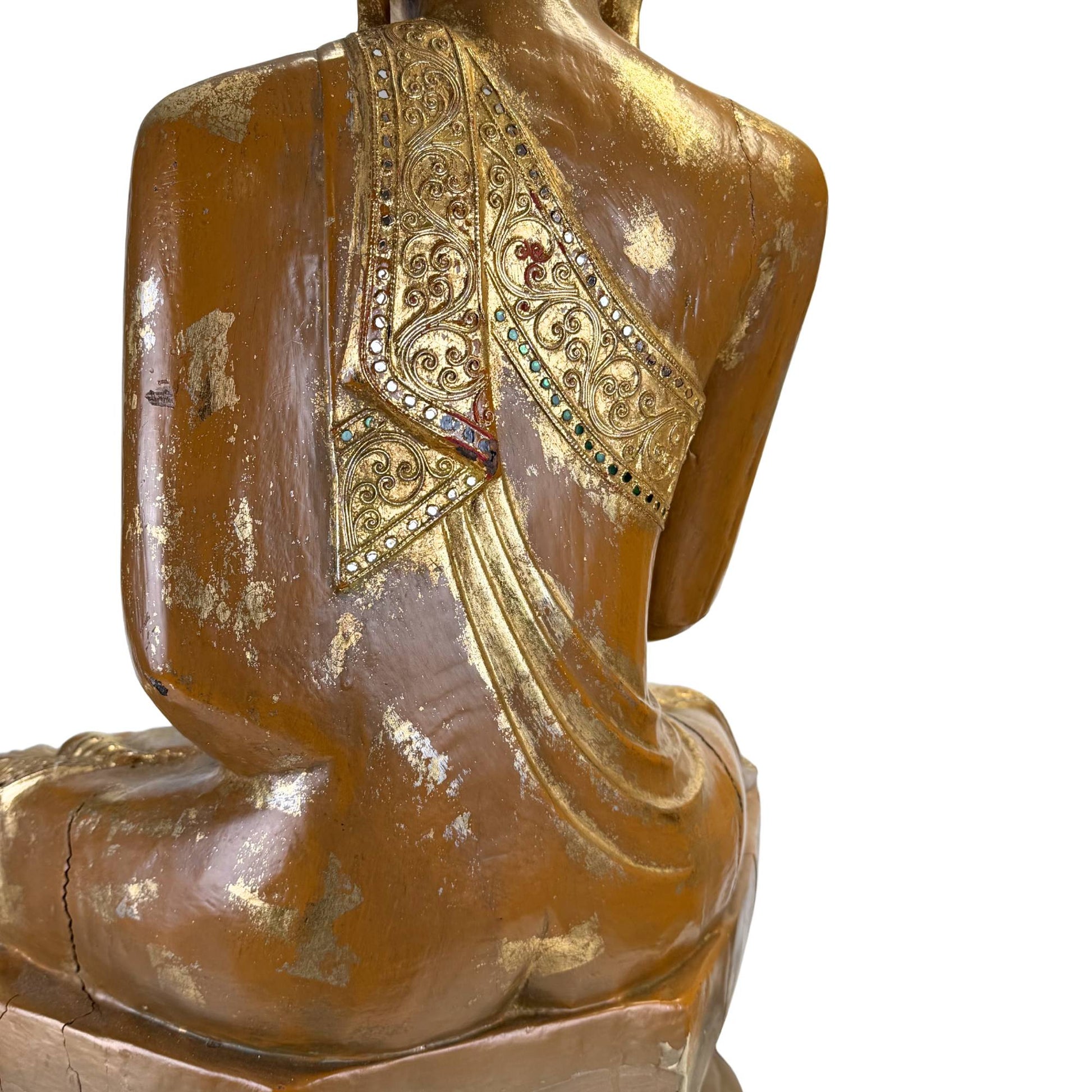 Back of large Burmese Buddha with old wooden throne, remnants of gold lacquer and hand-carved mantel decoration