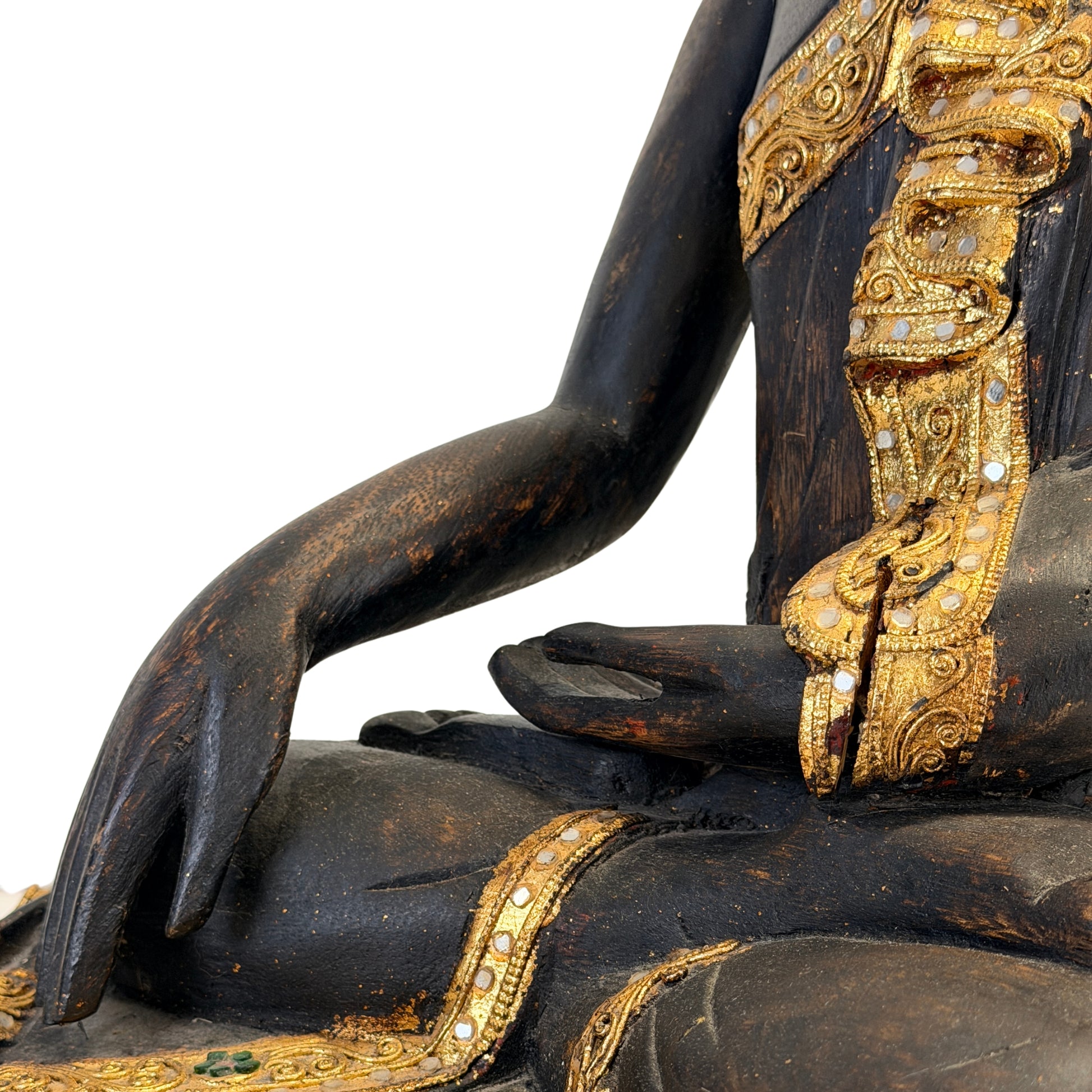 Detail of the gilded robe with decorative mirror glass on the Burmese Buddha