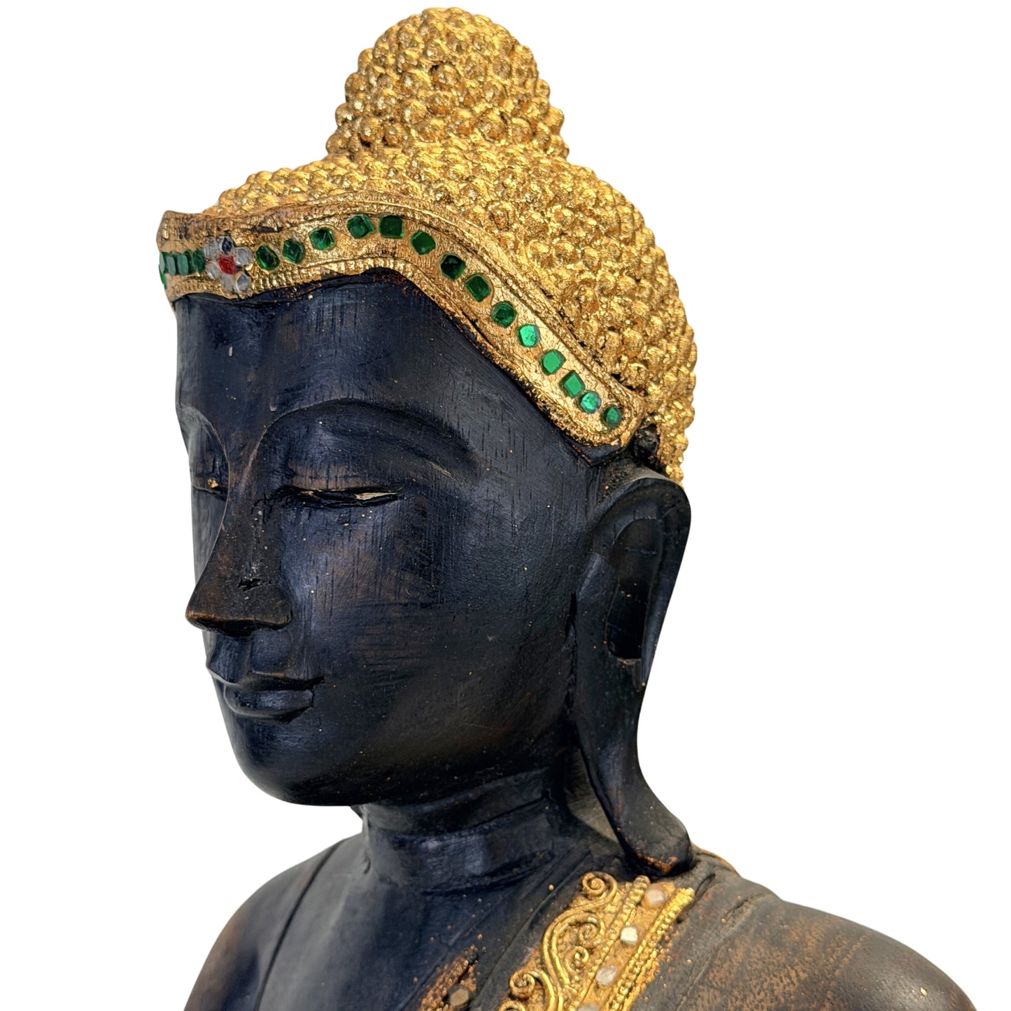 Close-up of the Buddha’s face with gilded hair curls and green glass inlay