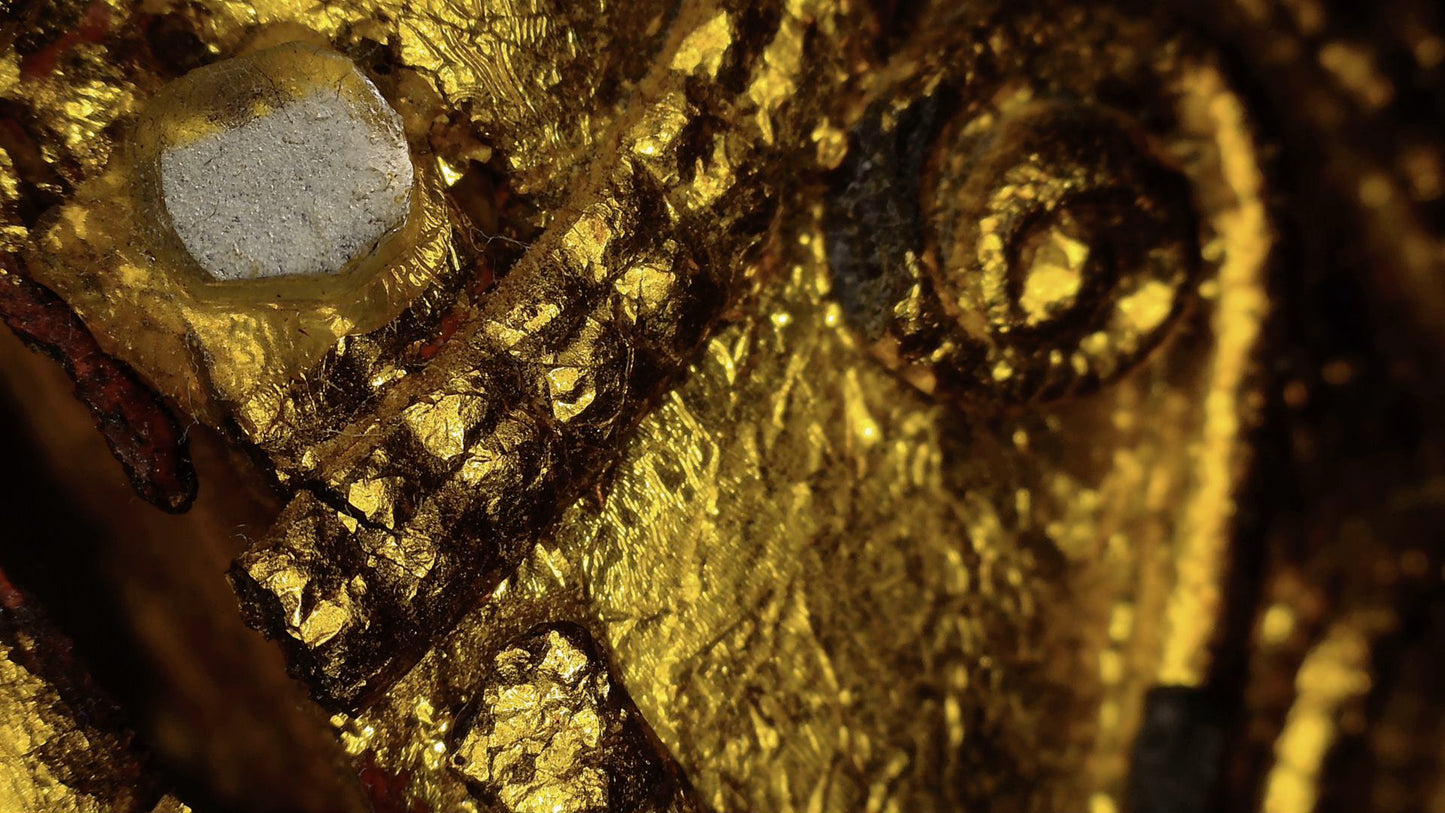 Microscope detail of faceted mirror glass within the gilded decoration