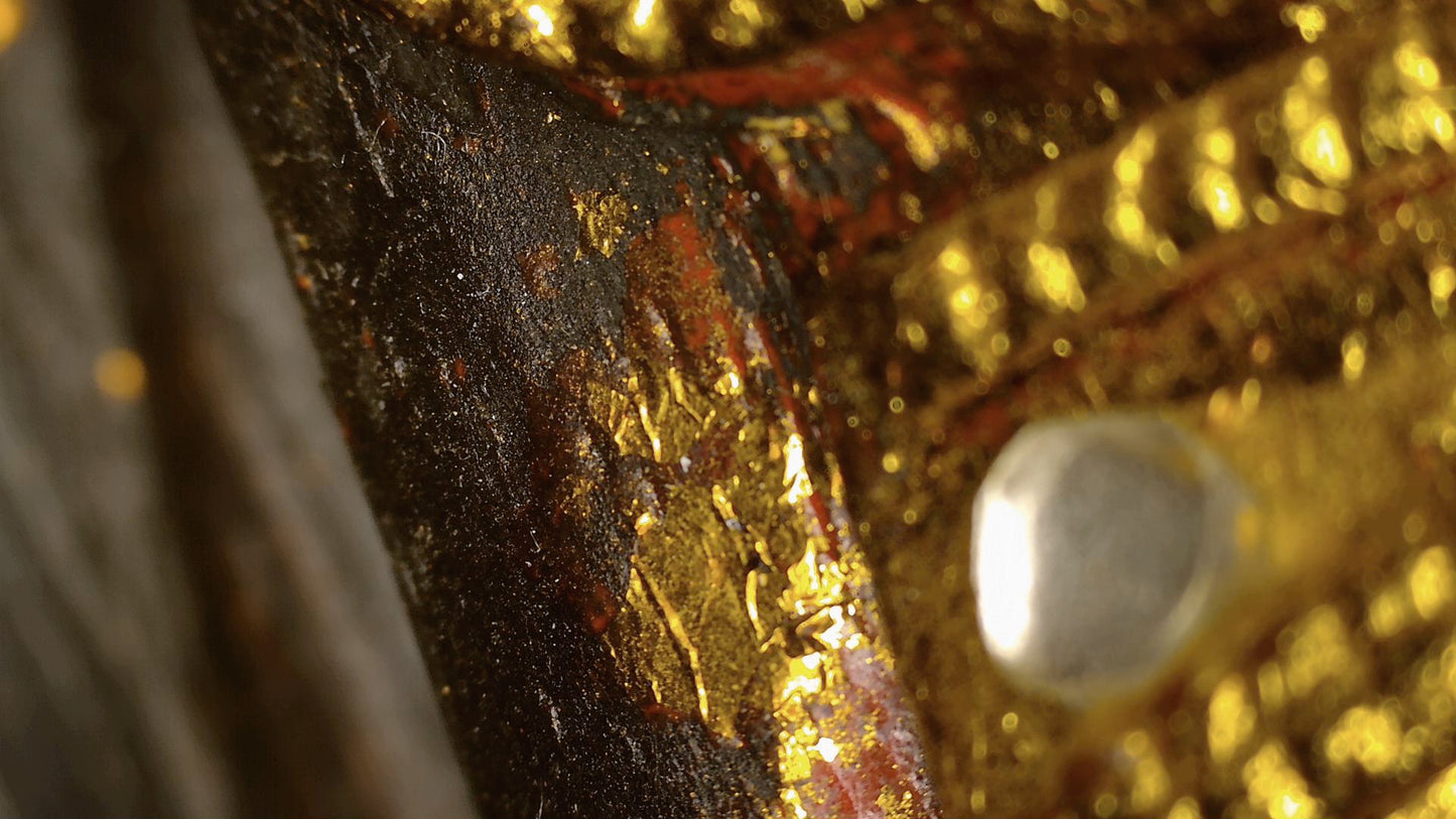 Microscope detail of black lacquer, red ground and remnants of gilding