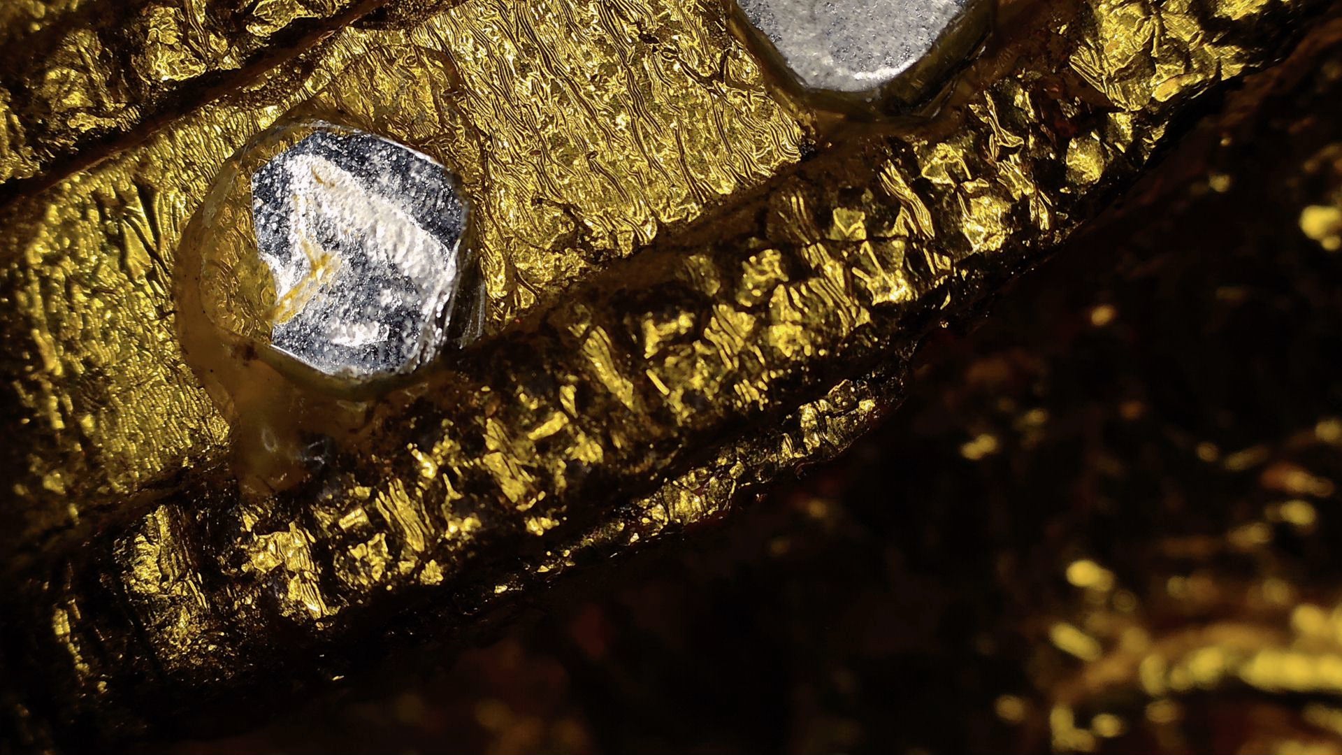 Microscope detail of mirror glass and layered old gilding