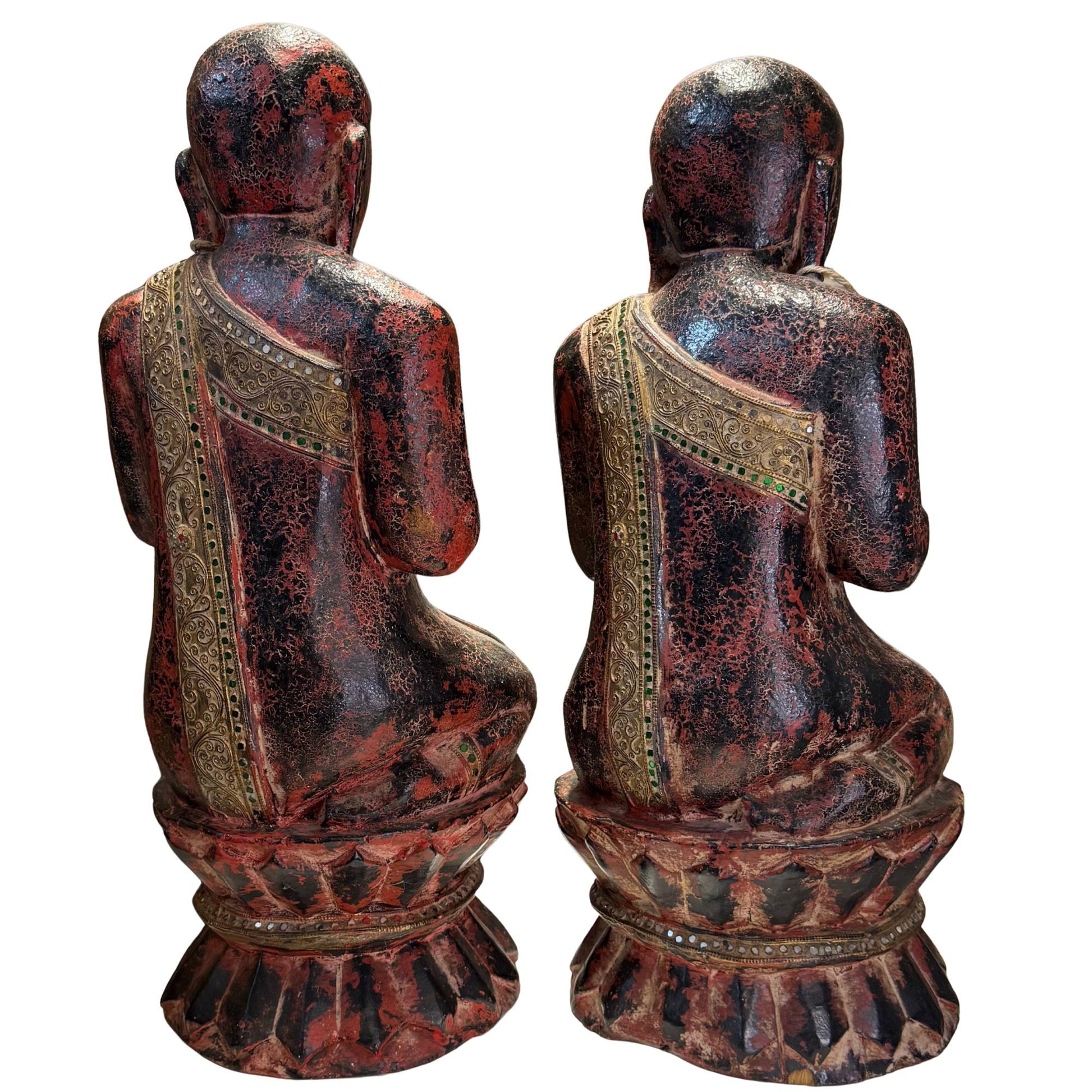 Burmese monk statues with hands in the Anjali Mudra veneration gesture.