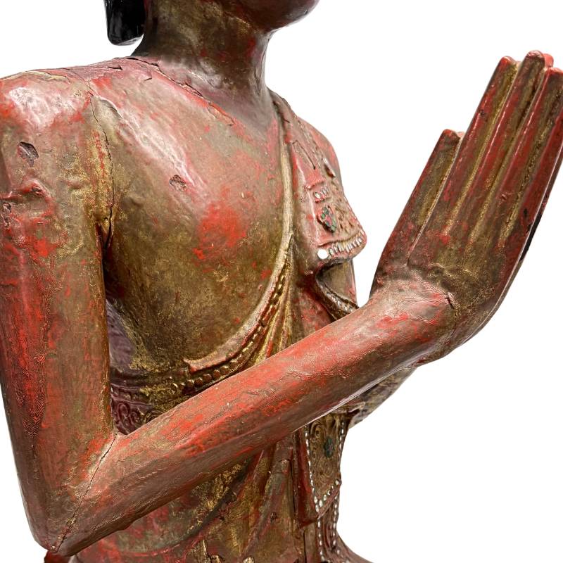 Burmese temple statue of a monk in a prayer posture
