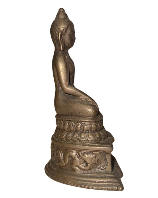 Bronze Buddha statue with decorative elephant panels on the throne base
