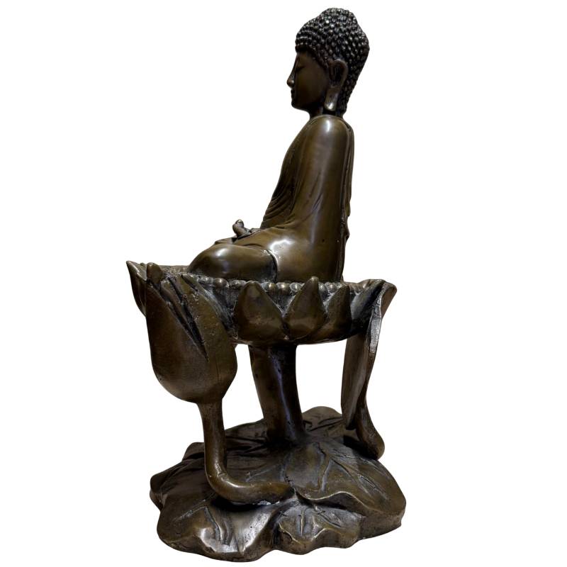 Buddha statue on a lotus seat with symbolism of purity, growth, and enlightenment