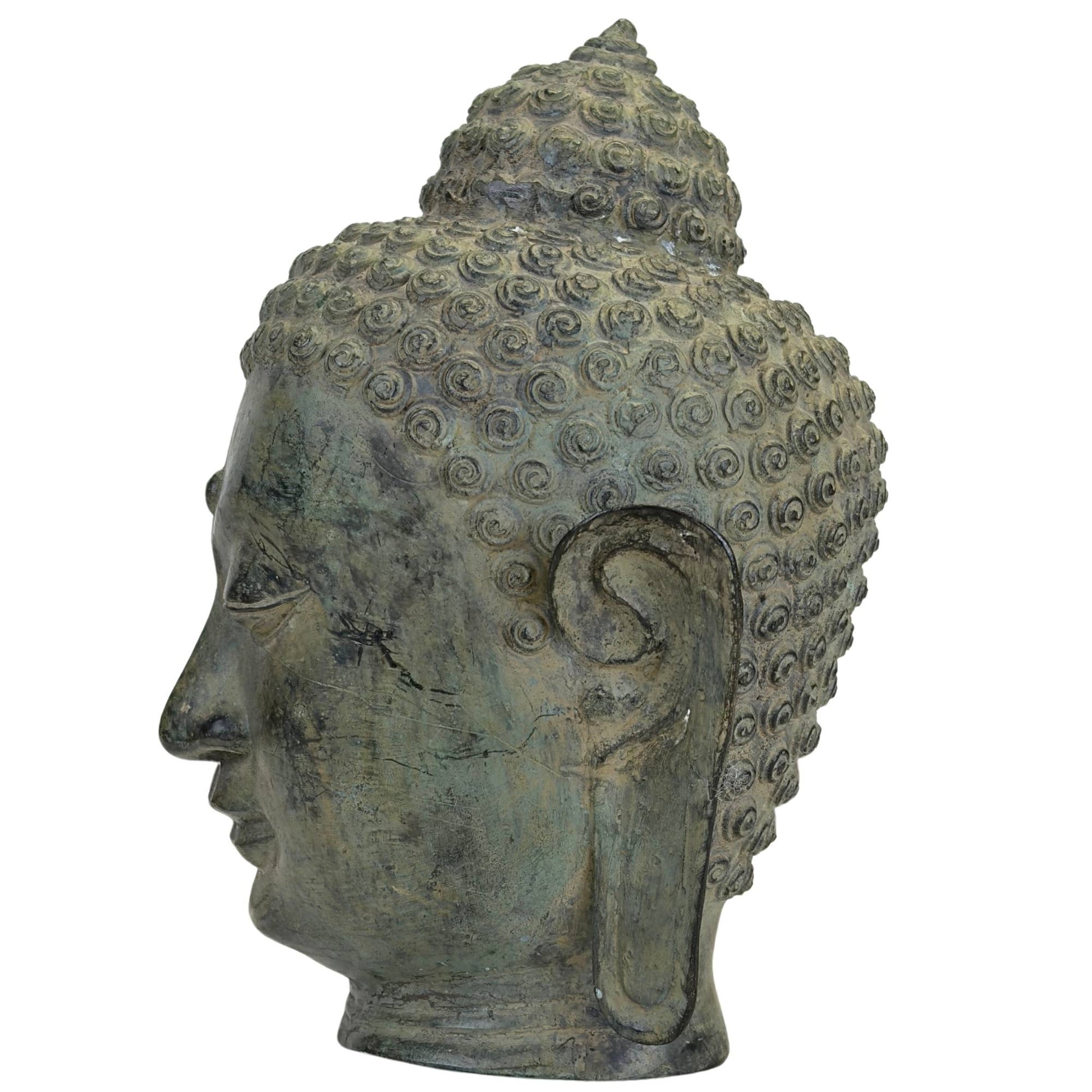 Detail of Buddha head with long earlobes and serene expression