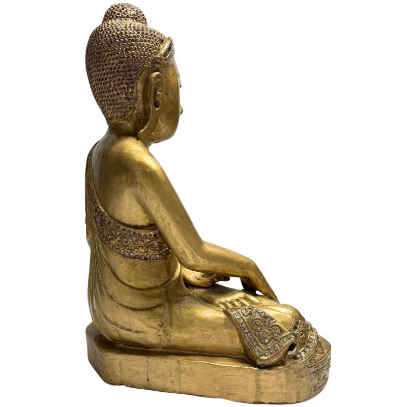 wooden Buddha statue with gilding and a peaceful appearance
