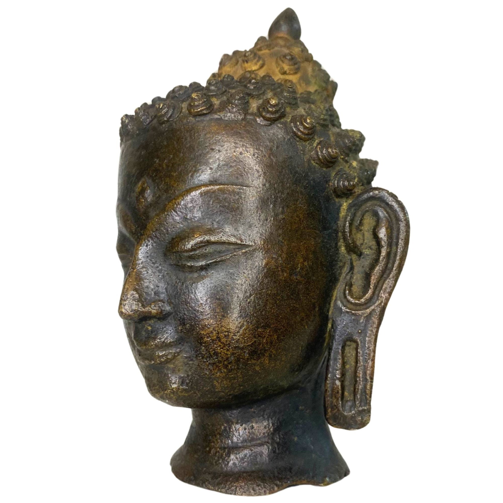 The three-quarter view of the Buddha emphasizes the spiritual aura of the ancient bronze.