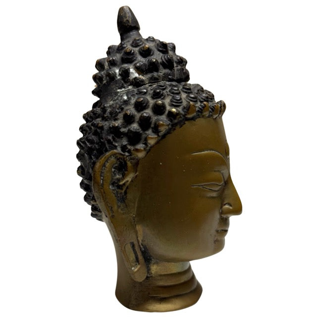 Pre-industrial fire-gilded Buddha head from Nepal with visible age and wear