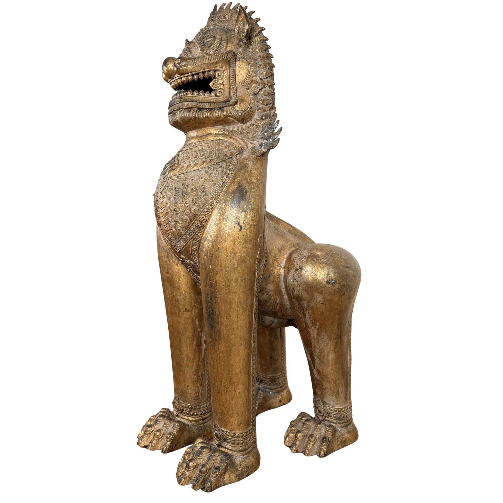 Buddhist temple guardian from Siam, gilded Sinja lion with old patina and spiritual protective symbolism