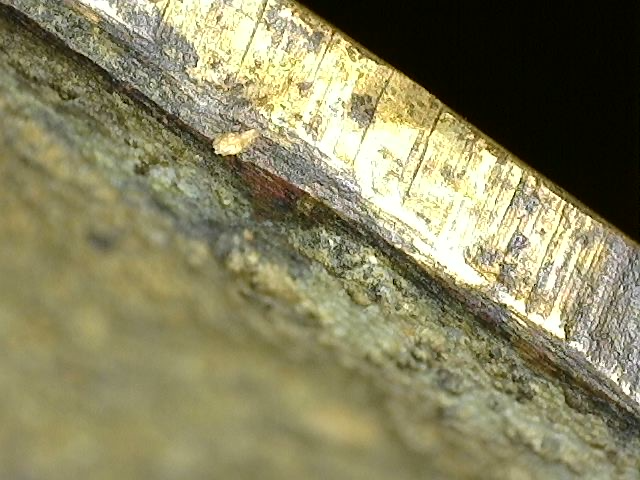 Microscopic layered patina structure on antique fire-gilded Brahma statue