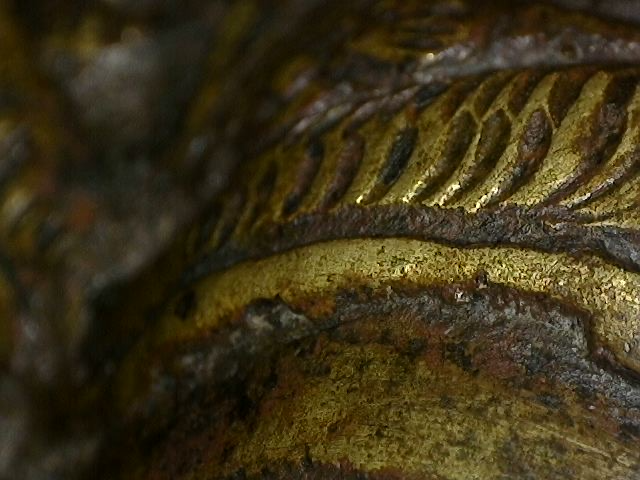 Microscope detail of ritual contact wear on bronze Brahma statue