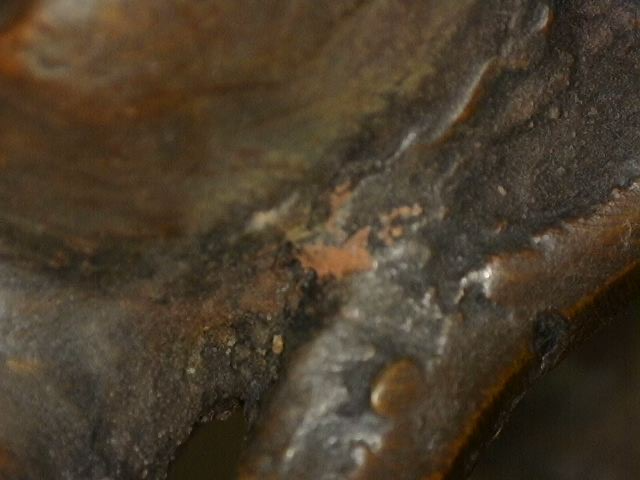 Microscope image of natural aging on bronze Buddha with meditation mudra