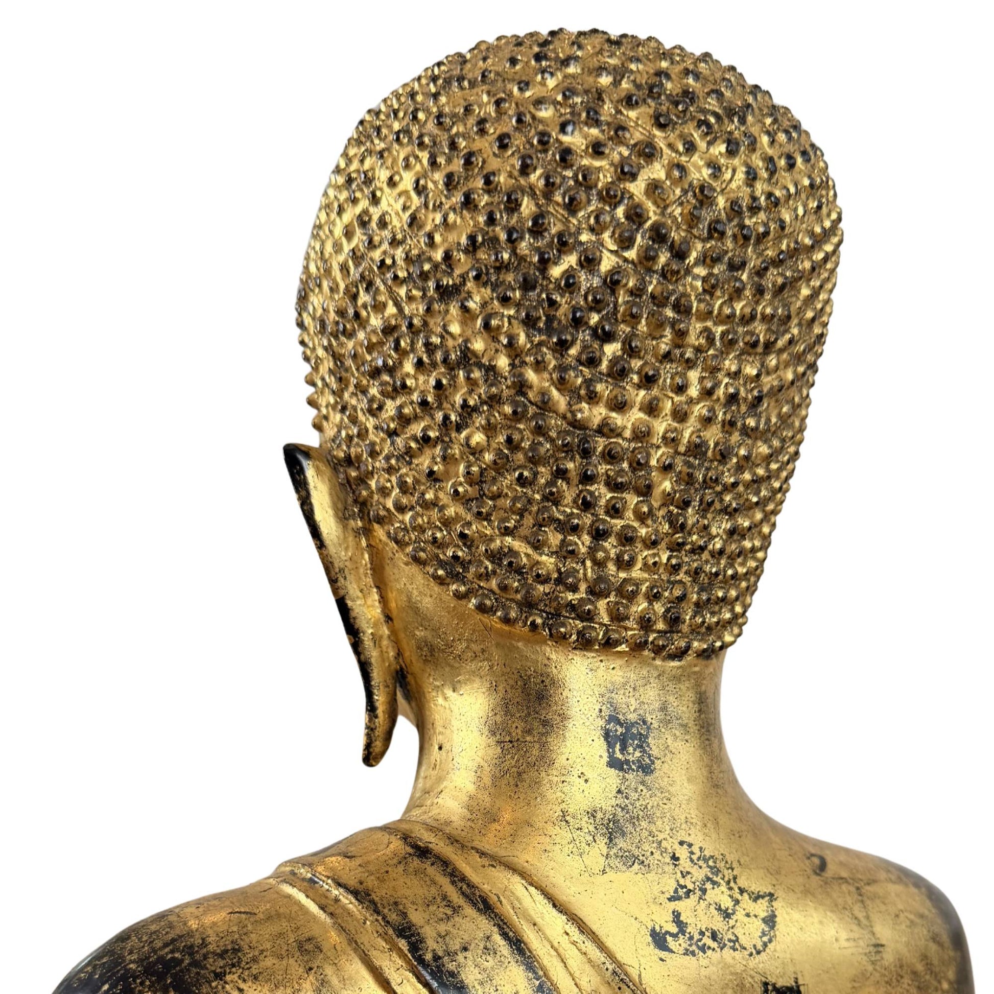 Detail of bronze Buddha statue with hand position, old patina, fire gilding and devotional character