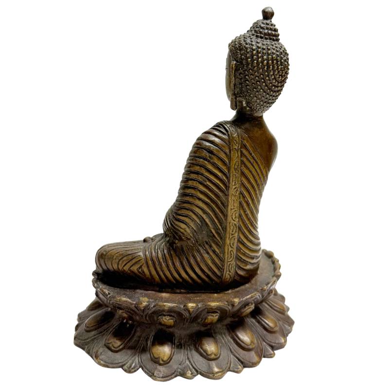 Bronze Buddha statue in meditation on lotus throne

