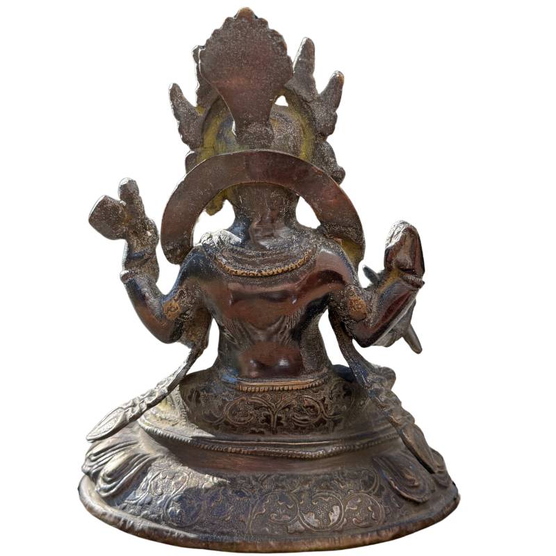 back details Rear view of the bronze Ganesha statue with visible details of the crown and throne.
