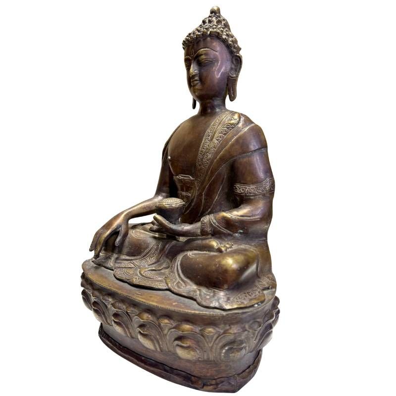 Side profile of an antique bronze Medicine Buddha from the Himalayan tradition