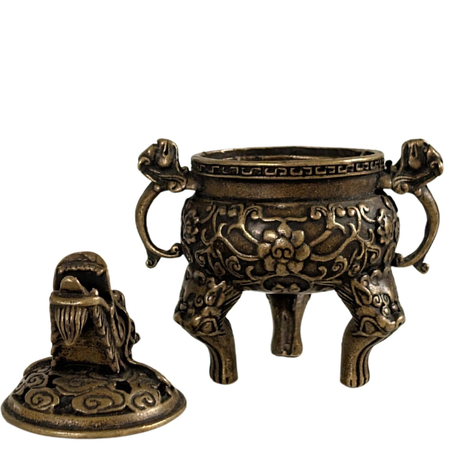 Detailed bronze incense burner with Chinese meander pattern and floral tendrils.