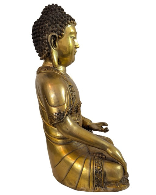 Seated Buddha in Bhumisparsha mudra executed in authentic fire-gilded bronze.