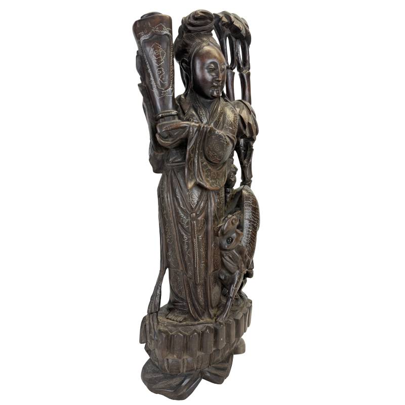 Detail of hand-hammered silver wire inlay on antique Chinese hardwood carving.