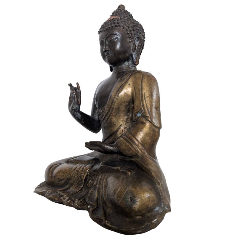 Face of Chinese bronze Buddha statue with a gentle expression