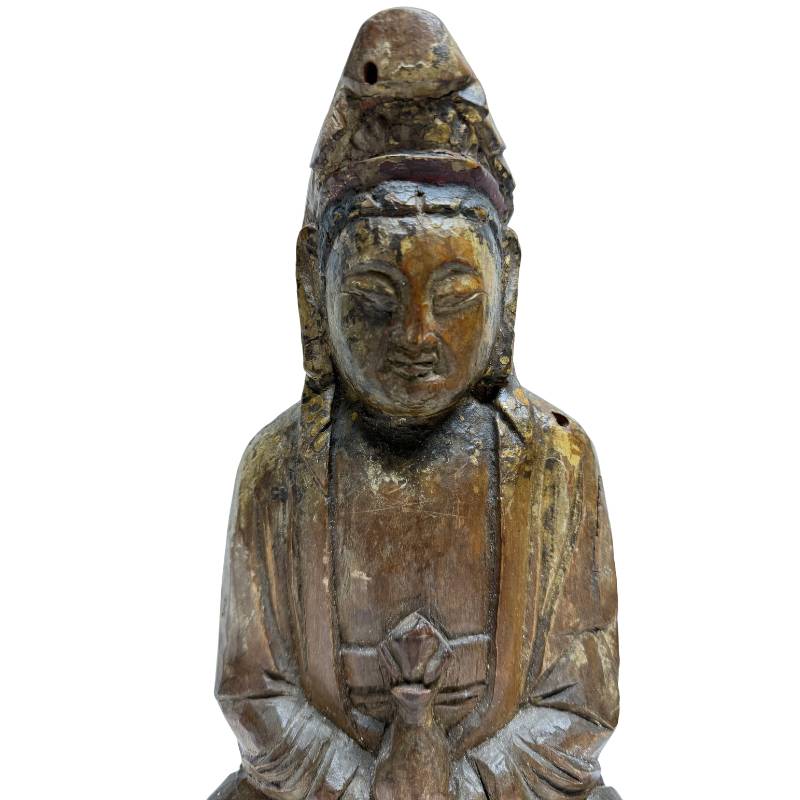Old wooden Guanyin statue from China with visible wear and depth