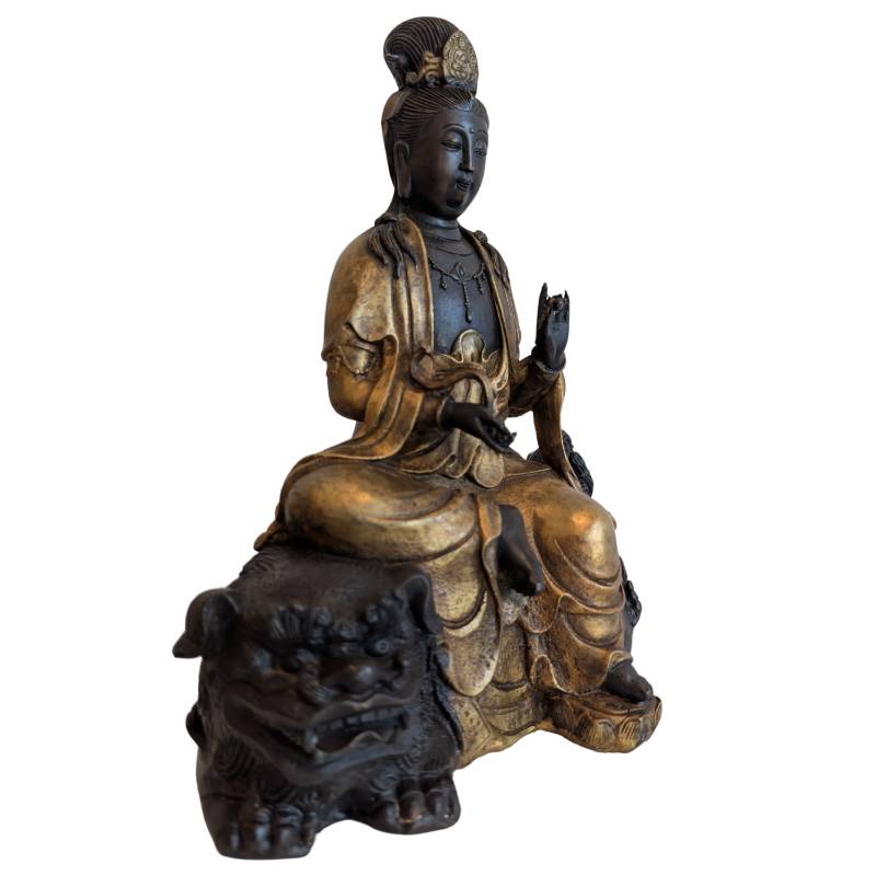 Seated Guanyin on a Chinese bronze lion