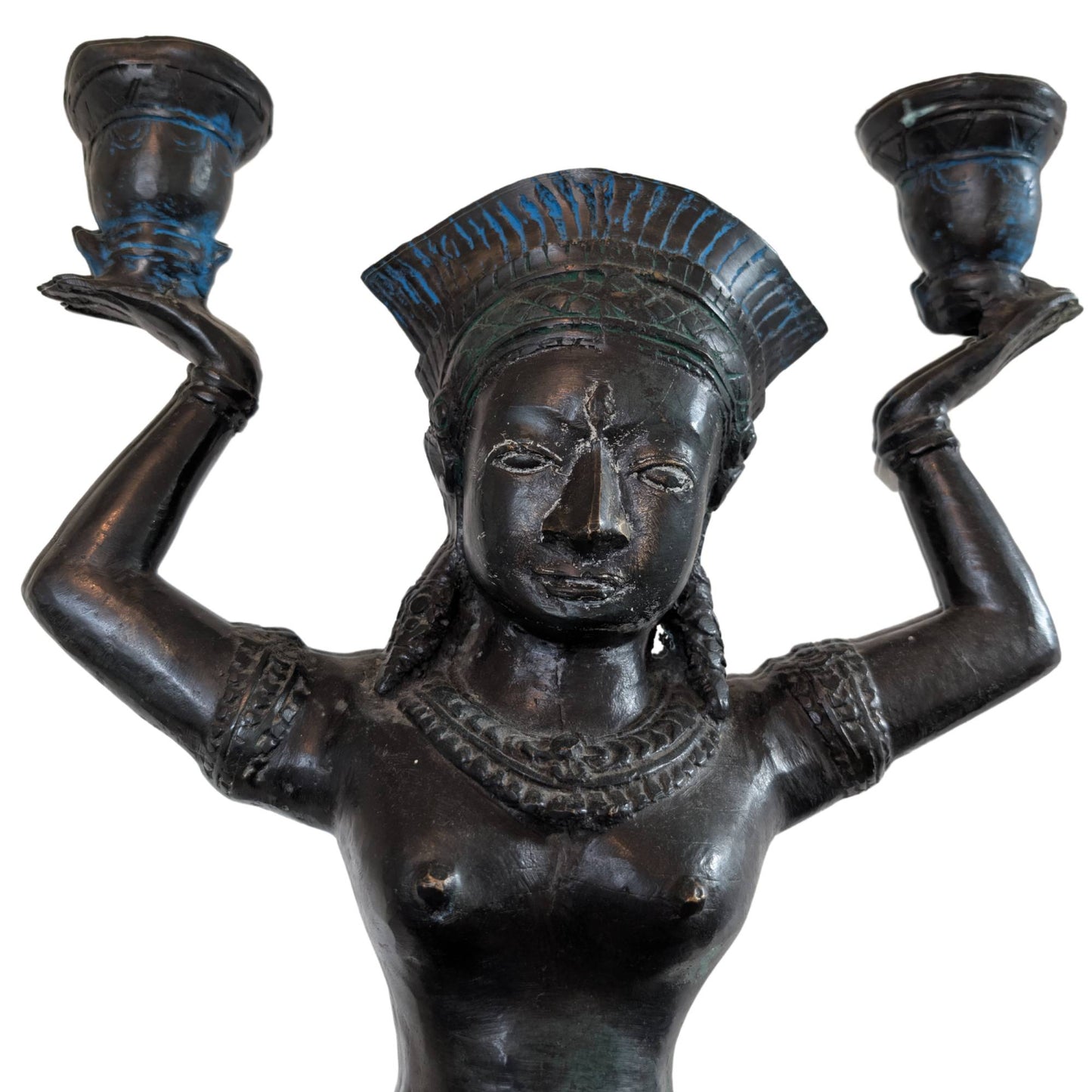 Close-up of the serene face of a Yakshi in bronze