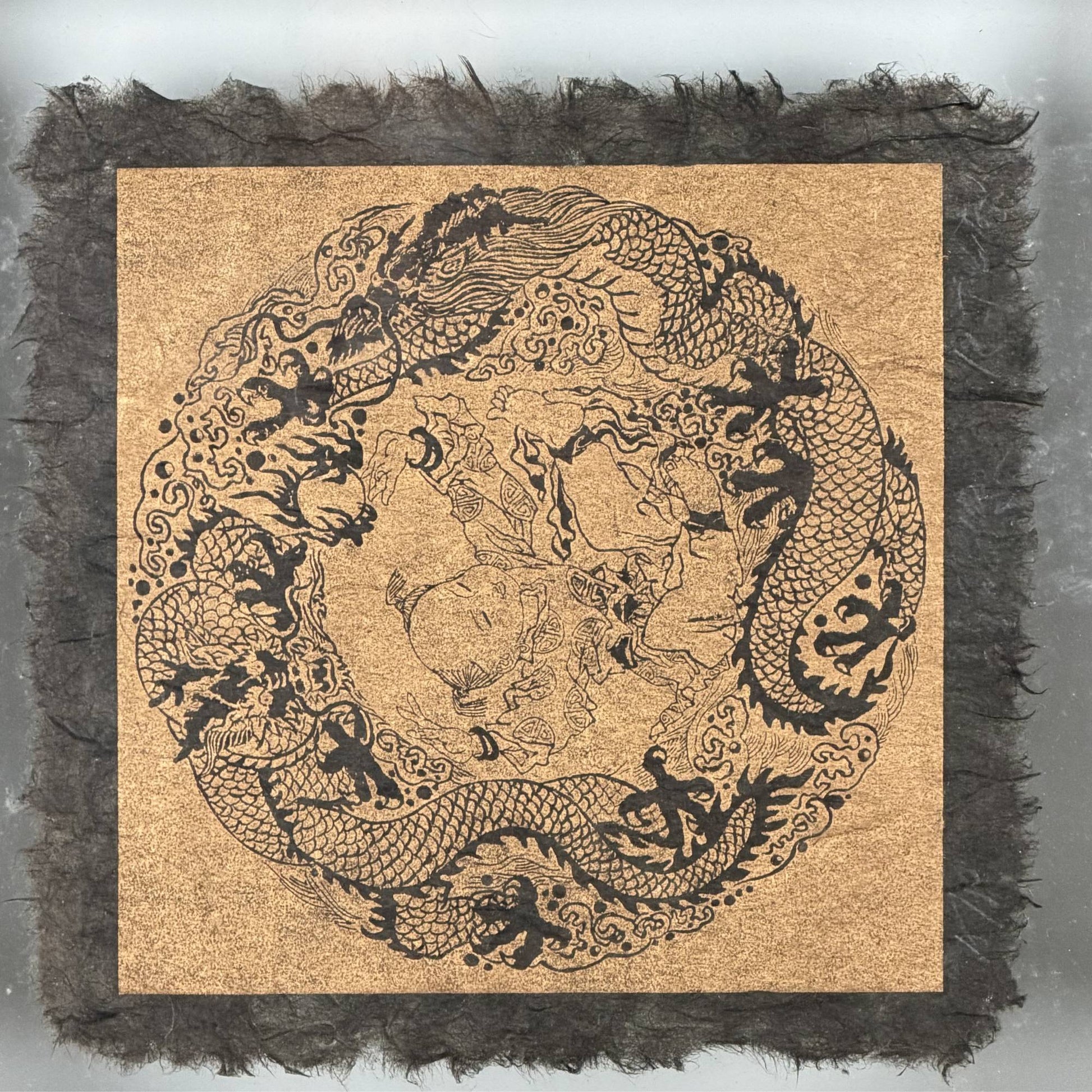 Finely detailed woodcut block print of two Chinese dragons hunting the flaming pearl, printed with traditional soot ink.