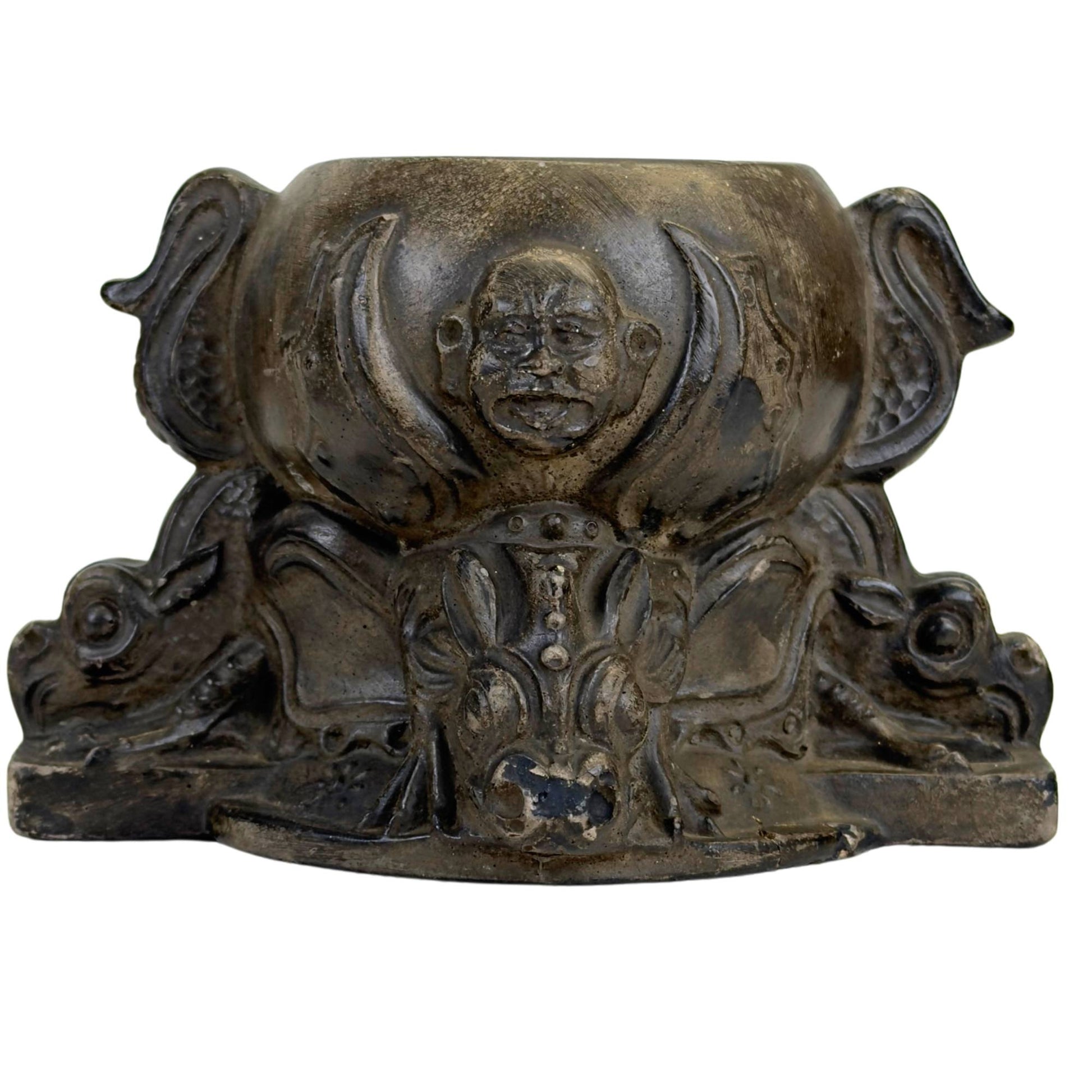 Decorative pot with dragons and expressive facial motifs