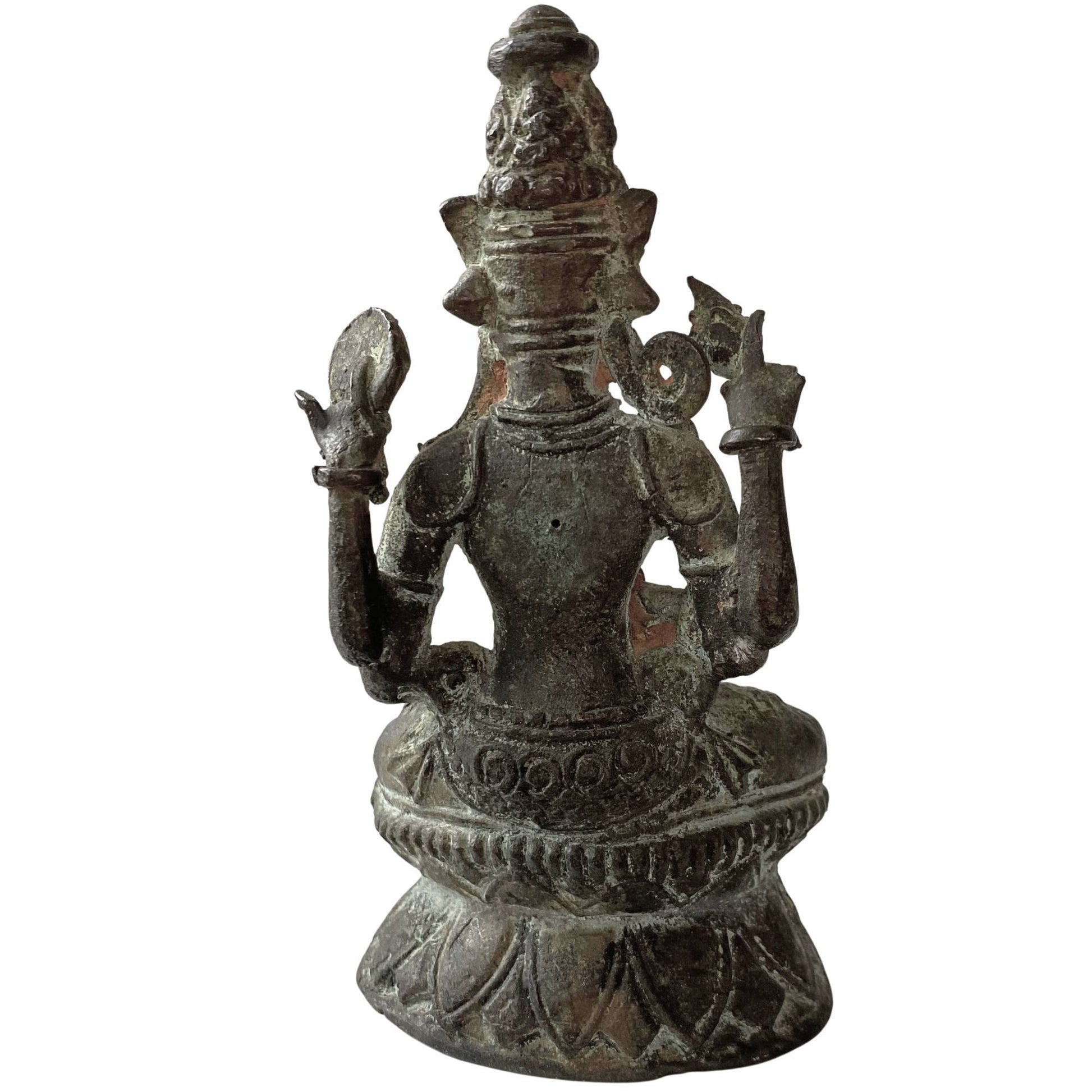 Close-up of the back of an antique Himalayan bronze statue of a bodhisattva