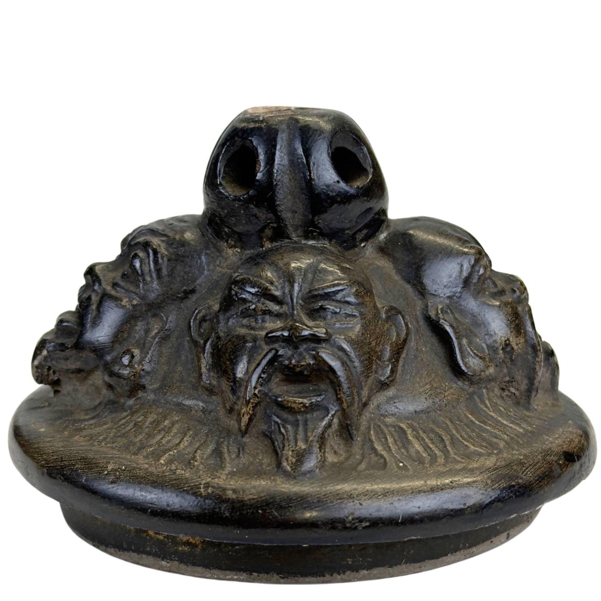 Detail of a dragon-shaped handle on an antique Belgian pot