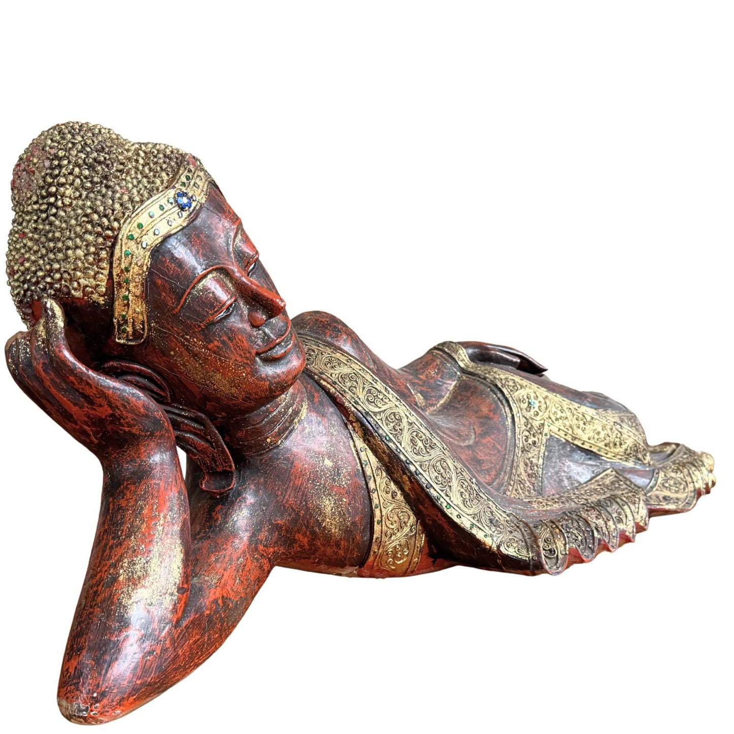 Detail of the serene face and hand of the Burmese Buddha in Parinirvana posture