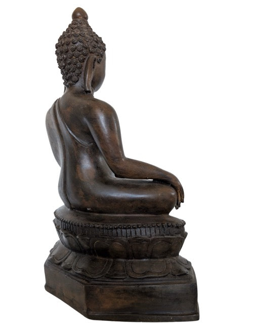 Close-up of the dark patina and bronze texture of the Buddha statue.