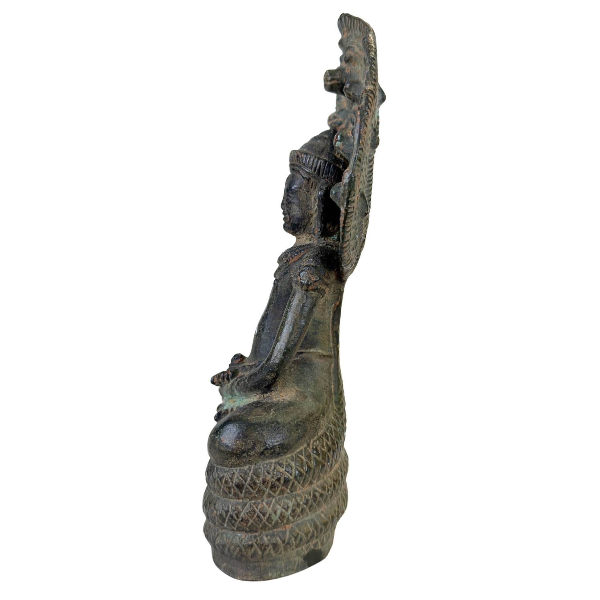 Buddha in meditative Dhyana Mudra posture on the coiled serpent throne.